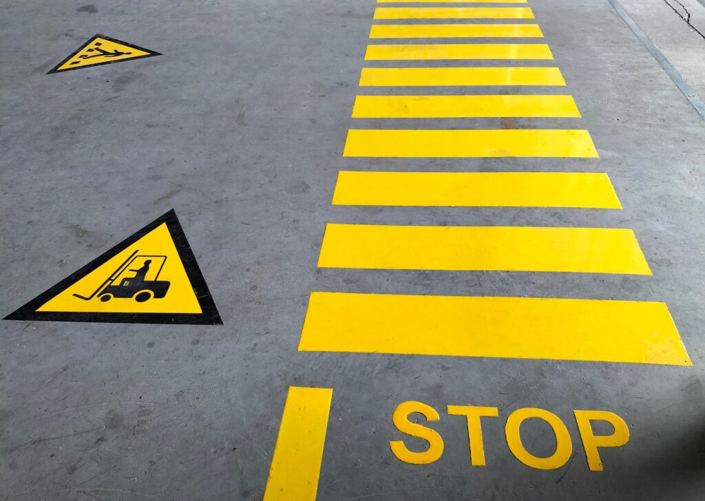 Freshly painted caution symbols on a concrete floor